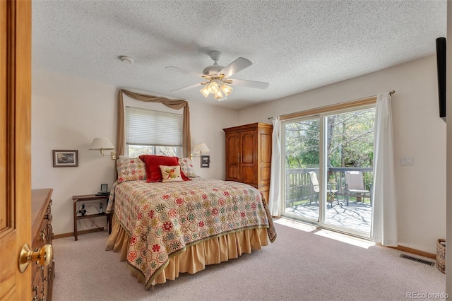 bedroom with access to exterior, light colored carpet, baseboards, a ceiling fan, and a textured ceiling