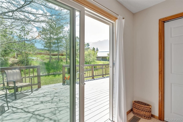 doorway with plenty of natural light and baseboards