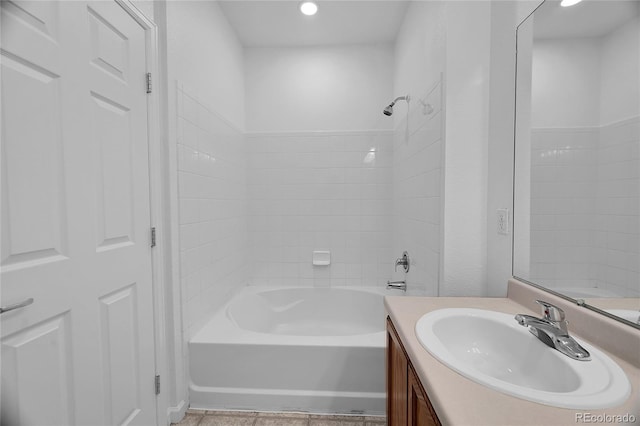 bathroom with vanity, tiled shower / bath, and tile patterned floors