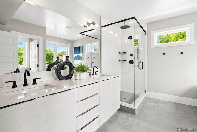 1500 S Elizabeth St, Denver, CO 80210 - bathroom with a shower stall, double vanity, baseboards, and recessed lighting