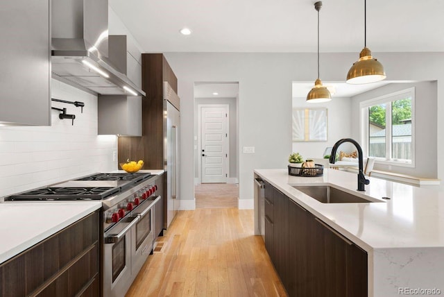 1500 S Elizabeth St, Denver, CO 80210 - kitchen with wall chimney exhaust hood, premium appliances, a sink, modern cabinets, and tasteful backsplash