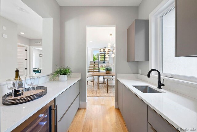 1500 S Elizabeth St, Denver, CO 80210 - kitchen featuring a sink, gray cabinetry, modern cabinets, light wood-type flooring, and light countertops
