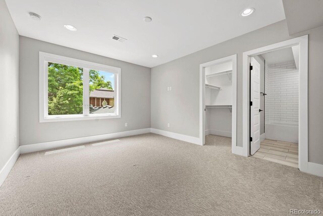 1500 S Elizabeth St, Denver, CO 80210 - unfurnished bedroom with light carpet, baseboards, recessed lighting, a walk in closet, and connected bathroom