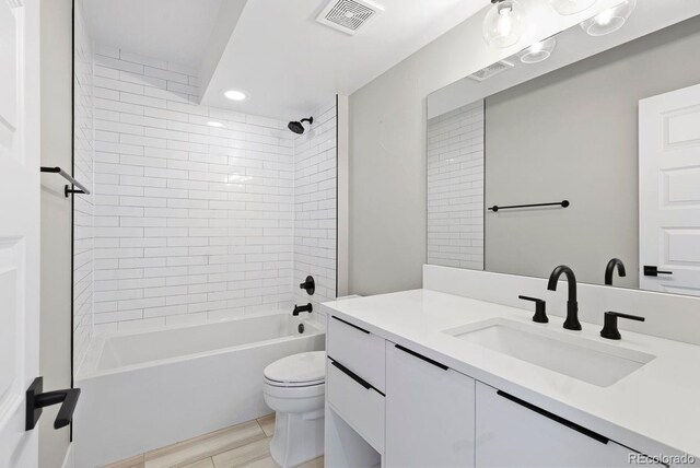 1500 S Elizabeth St, Denver, CO 80210 - bathroom featuring vanity, toilet, bathing tub / shower combination, and recessed lighting