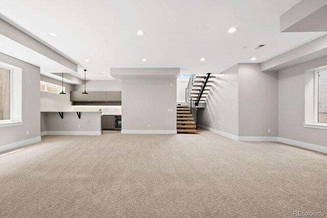 1500 S Elizabeth St, Denver, CO 80210 - unfurnished living room with stairway, light colored carpet, baseboards, and recessed lighting