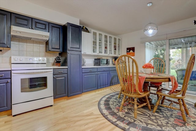 kitchen with glass insert cabinets, light countertops, white electric range, under cabinet range hood, and white cabinetry