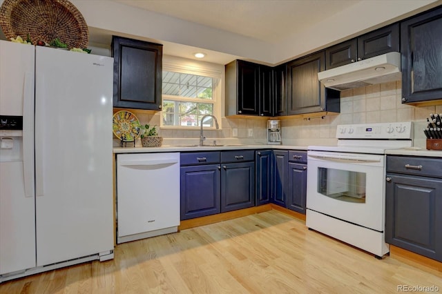 kitchen with white appliances, light countertops, and under cabinet range hood