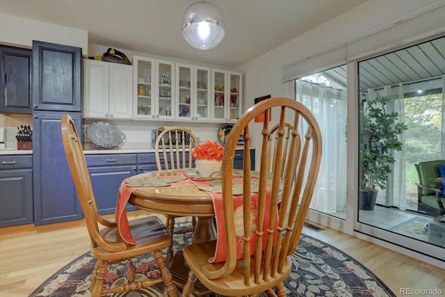 dining space featuring light wood-style floors and a healthy amount of sunlight