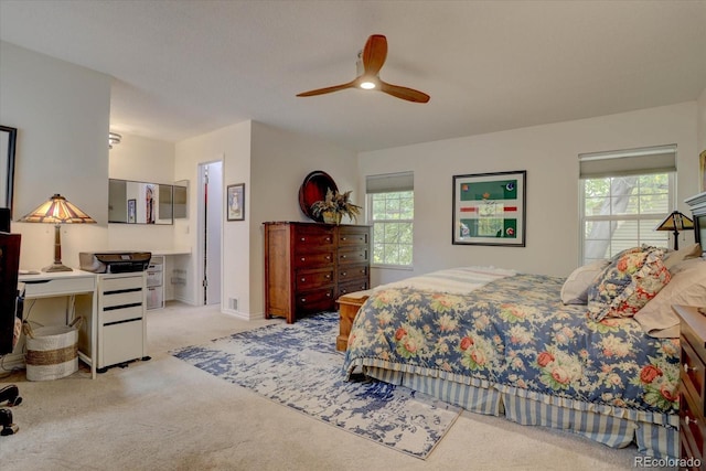 bedroom featuring light carpet and ceiling fan