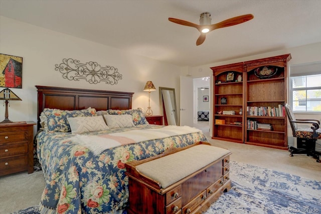 bedroom with ceiling fan and light colored carpet