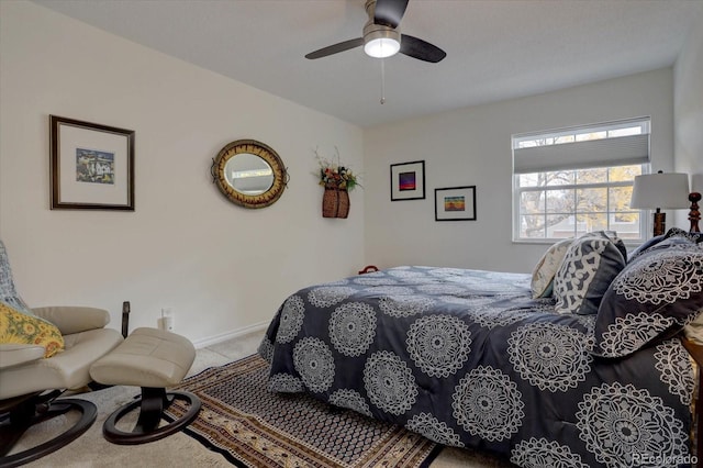 bedroom with ceiling fan, baseboards, and light colored carpet