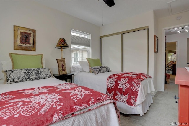 bedroom with a ceiling fan, a closet, and light carpet