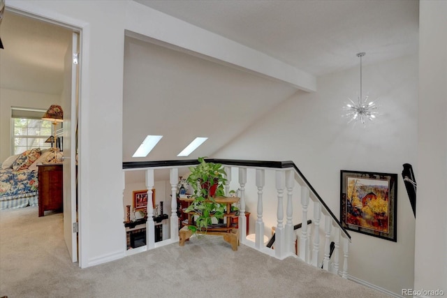 interior space featuring carpet floors, lofted ceiling with beams, and a chandelier