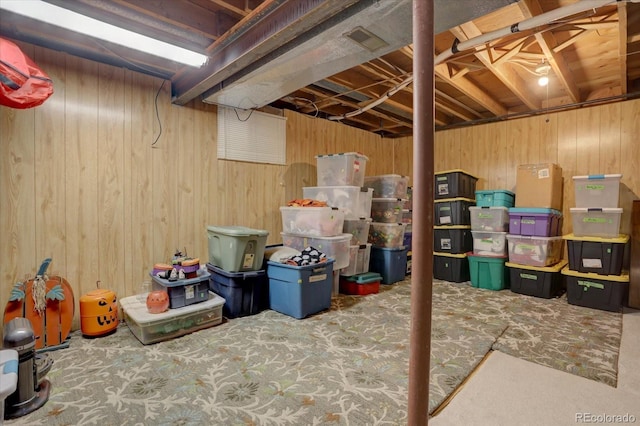 unfinished basement with visible vents and wood walls