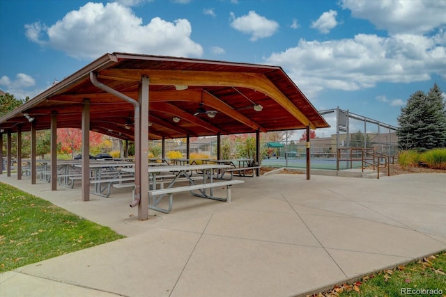 view of community featuring a tennis court