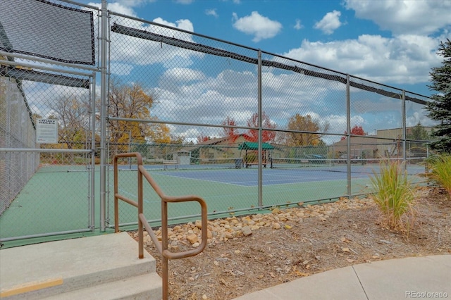 view of sport court featuring a gate and fence