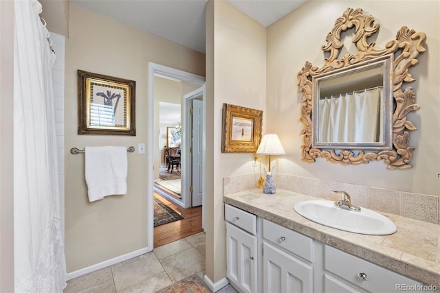 bathroom with tile patterned flooring, vanity, and baseboards