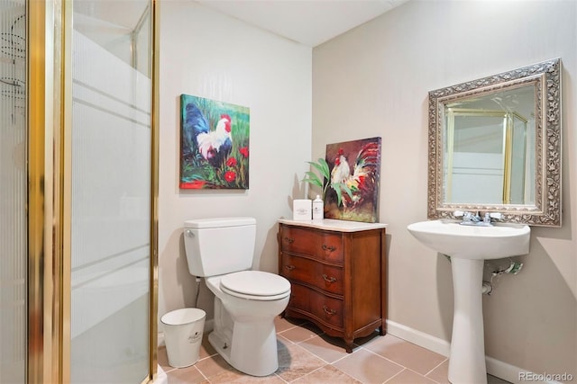 full bath featuring toilet, a stall shower, tile patterned flooring, and baseboards