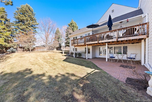 back of house with a lawn, a patio, french doors, fence, and a wooden deck