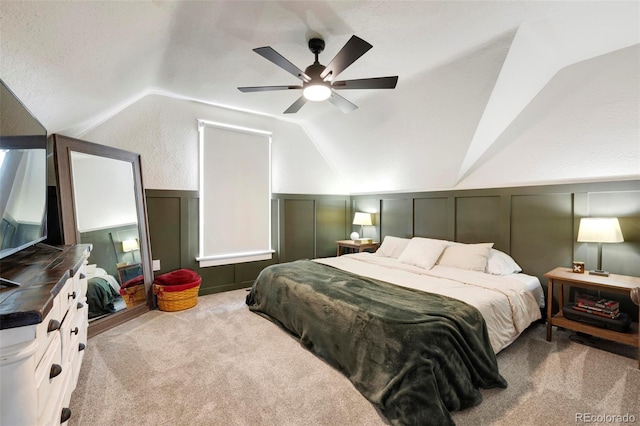 carpeted bedroom featuring lofted ceiling, a textured ceiling, and ceiling fan