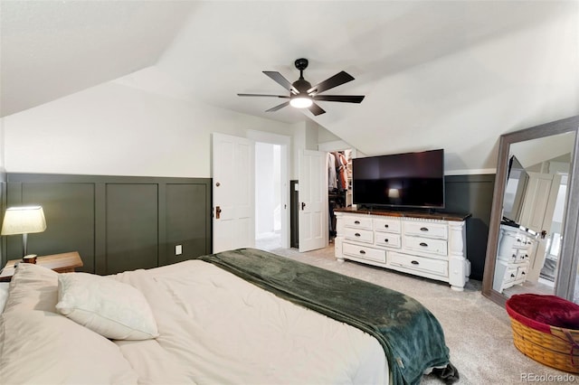 bedroom featuring vaulted ceiling, light colored carpet, and ceiling fan