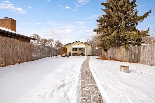 view of yard layered in snow