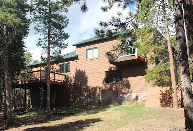 9274 Sandy Ln, Conifer, CO 80433 - rear view of house with a lawn and a wooden deck