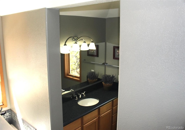 9274 Sandy Ln, Conifer, CO 80433 - bathroom featuring a textured wall and vanity