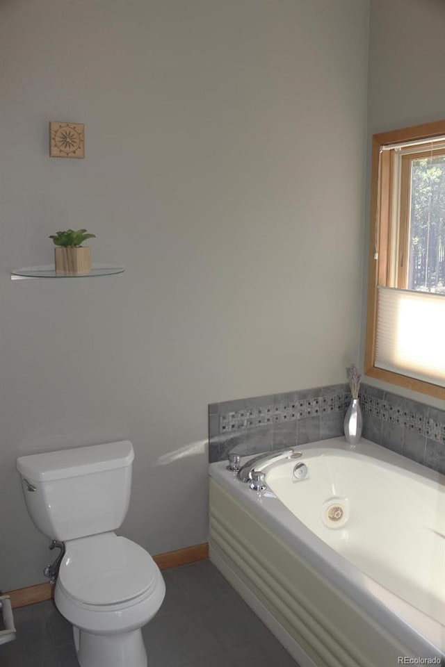 9274 Sandy Ln, Conifer, CO 80433 - bathroom featuring toilet, tile patterned floors, a garden tub, and baseboards