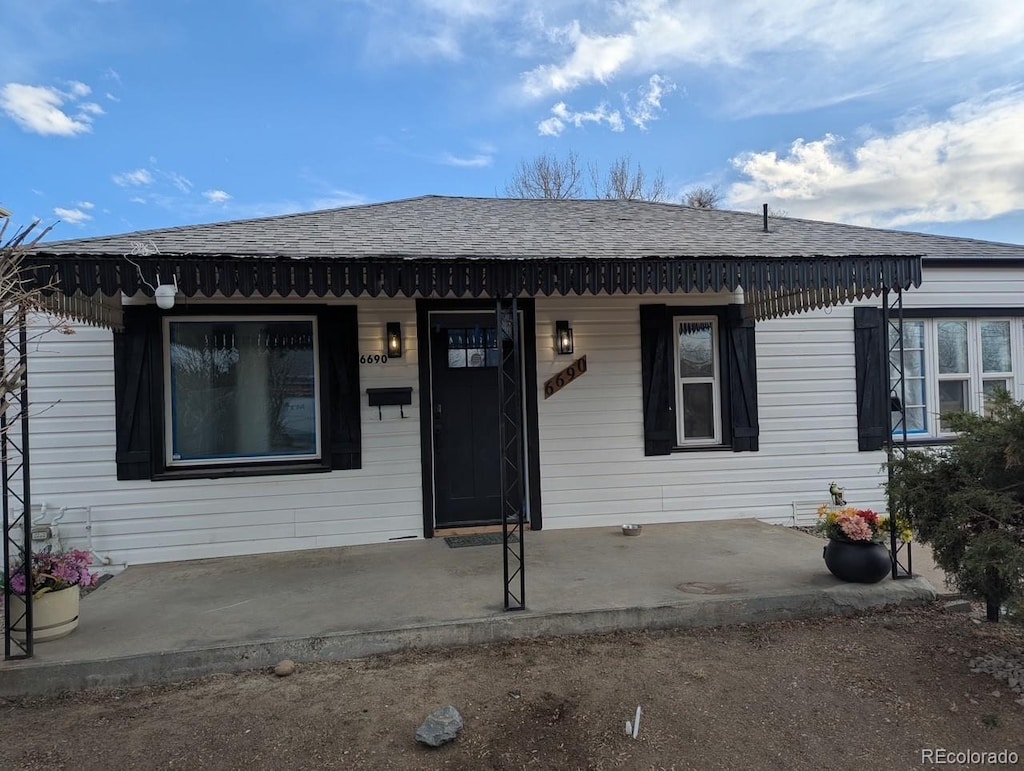 view of front of home with a shingled roof