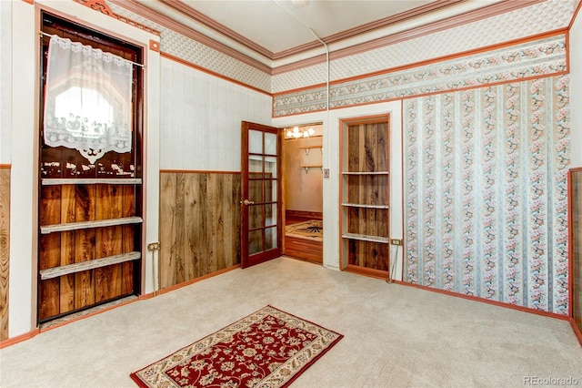 misc room featuring crown molding, french doors, and carpet flooring