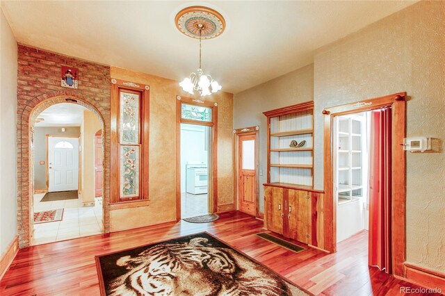 entrance foyer with a chandelier and hardwood / wood-style flooring