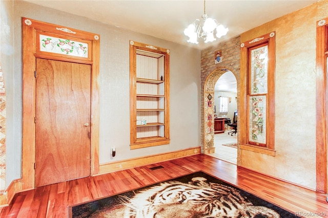 entrance foyer featuring a notable chandelier and hardwood / wood-style flooring