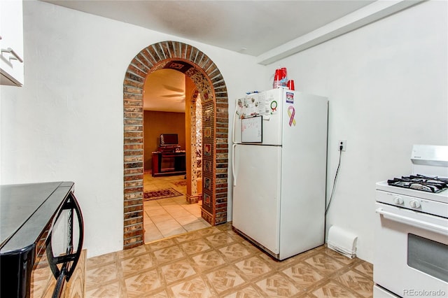 kitchen with light tile patterned flooring and white appliances