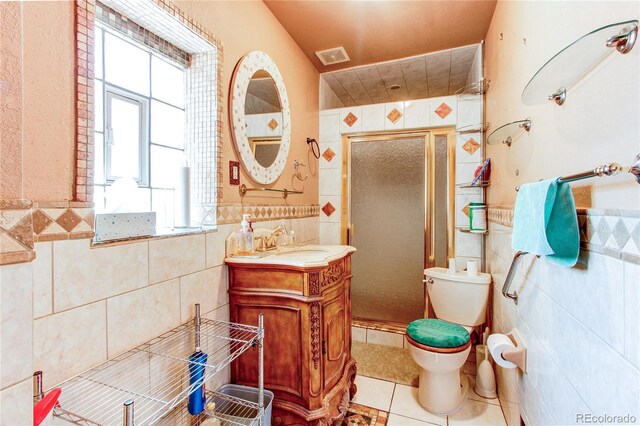 bathroom featuring tile walls, toilet, vanity, and tile patterned floors