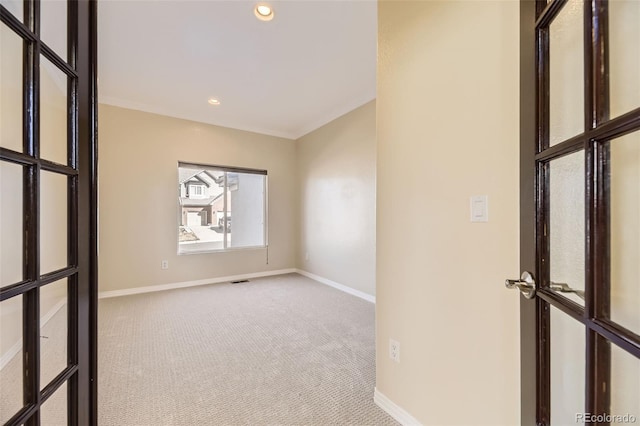 carpeted spare room featuring recessed lighting, visible vents, and baseboards