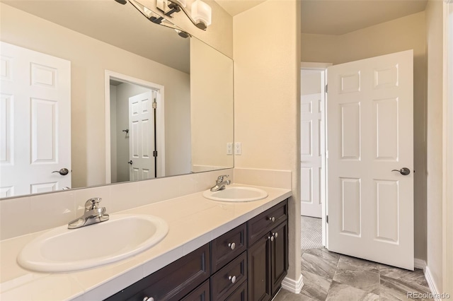 bathroom featuring double vanity and a sink