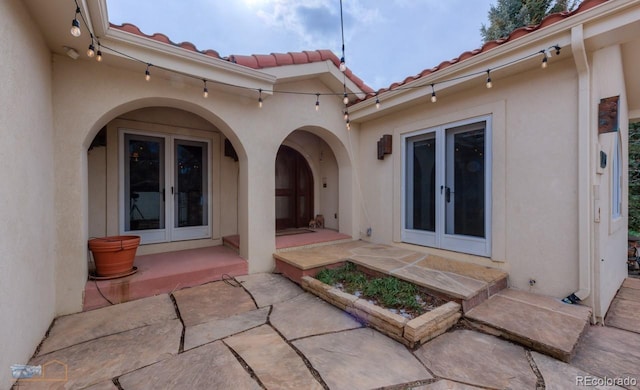 7022 Secrest Ct, Arvada, CO 80007 - exterior space with a patio, stucco siding, french doors, and a tiled roof