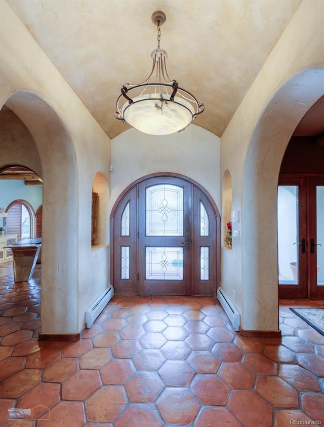 7022 Secrest Ct, Arvada, CO 80007 - foyer featuring an inviting chandelier, a baseboard heating unit, lofted ceiling, and arched walkways