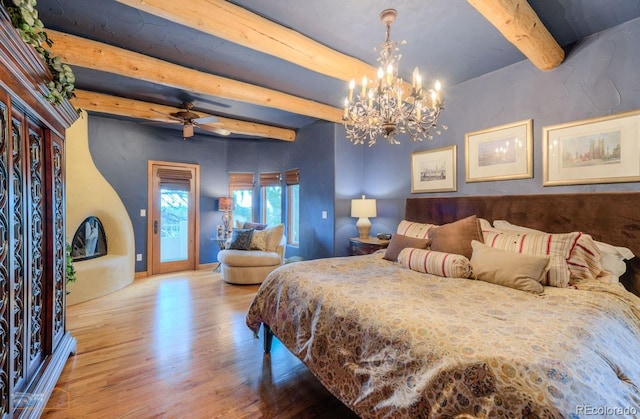 7022 Secrest Ct, Arvada, CO 80007 - bedroom featuring an inviting chandelier, access to outside, beamed ceiling, and wood finished floors