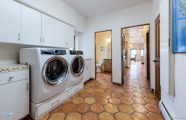 7022 Secrest Ct, Arvada, CO 80007 - laundry room with washing machine and clothes dryer, cabinet space, and a baseboard heating unit