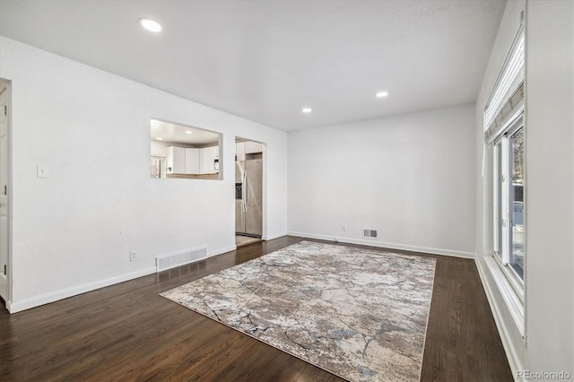 empty room featuring dark wood-type flooring