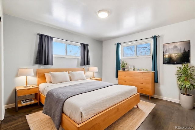 bedroom featuring multiple windows and dark wood-type flooring