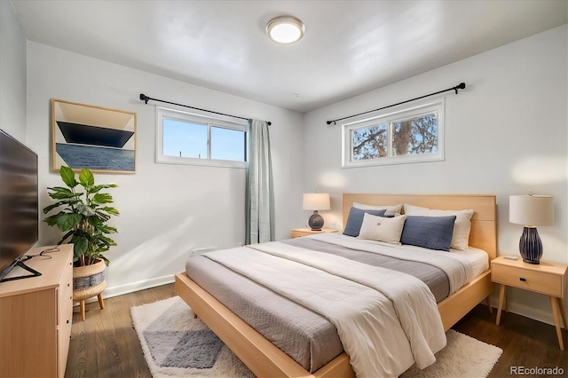 bedroom with dark hardwood / wood-style flooring