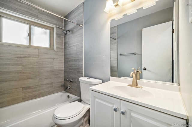 full bathroom with vanity, toilet, and tiled shower / bath combo