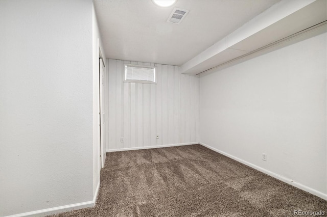 basement featuring dark colored carpet