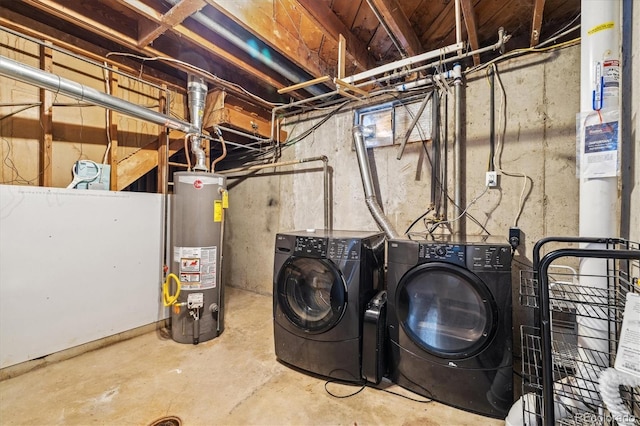 clothes washing area with washer and dryer and water heater