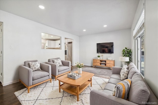 living room with baseboards, wood finished floors, and recessed lighting