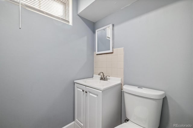 half bathroom featuring toilet and vanity