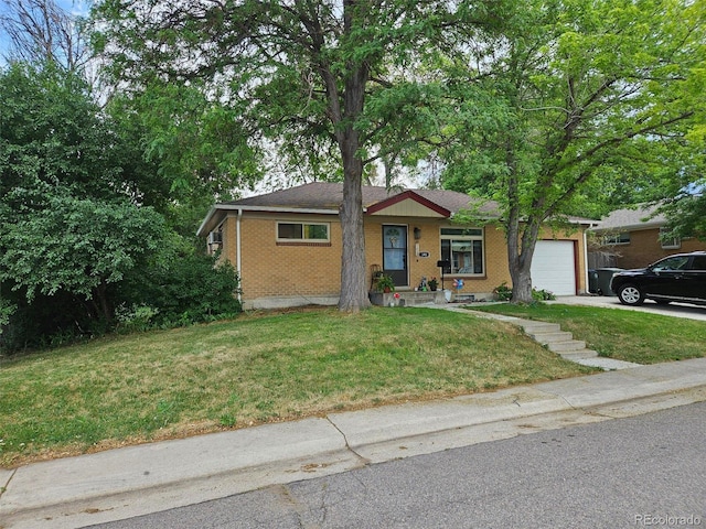 single story home with a garage, a front yard, brick siding, and driveway